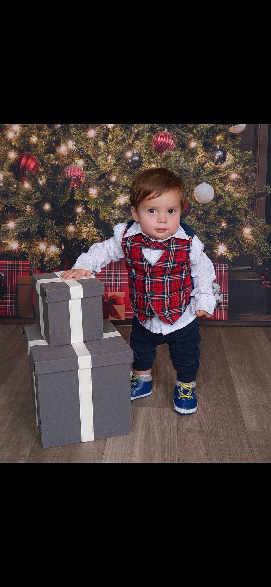 Waylon joined the competition — help win amazing prizes! baby, baby_toddler_clothing, christmas, christmas_decoration, christmas_ornament, christmas_tree, event, fun, happy, holiday, holiday_ornament, pattern, person, plaid, sitting, sleeve, sock, standing, tartan, toddler
