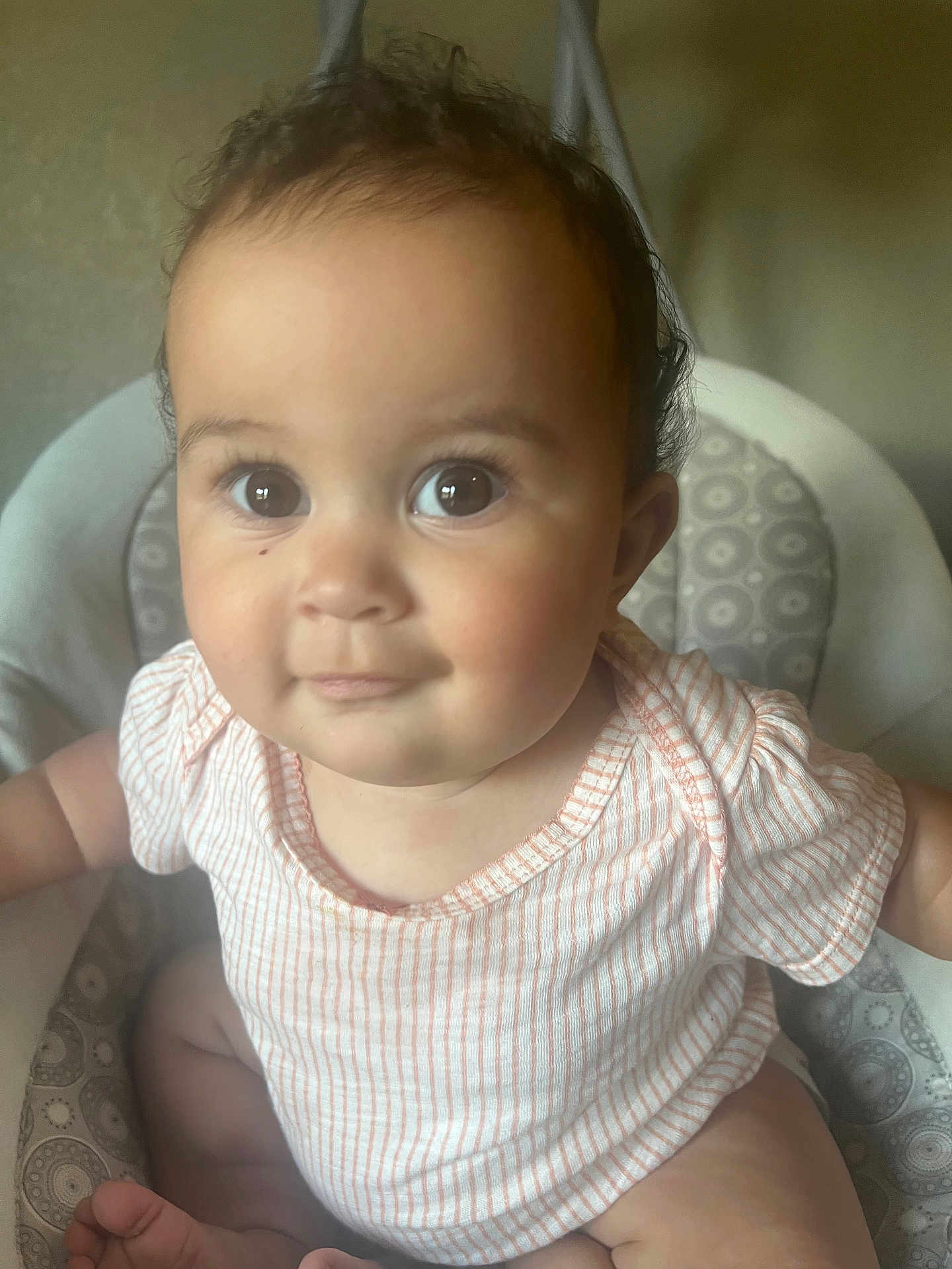 Summer Sage joined the competition — help win amazing prizes! baby, child, infant, face, eyes, smile, sitting, clothing, striped_shirt, patterned_chair, indoors, cute, young_child, person, skin, head, hair, arm, foot, photography