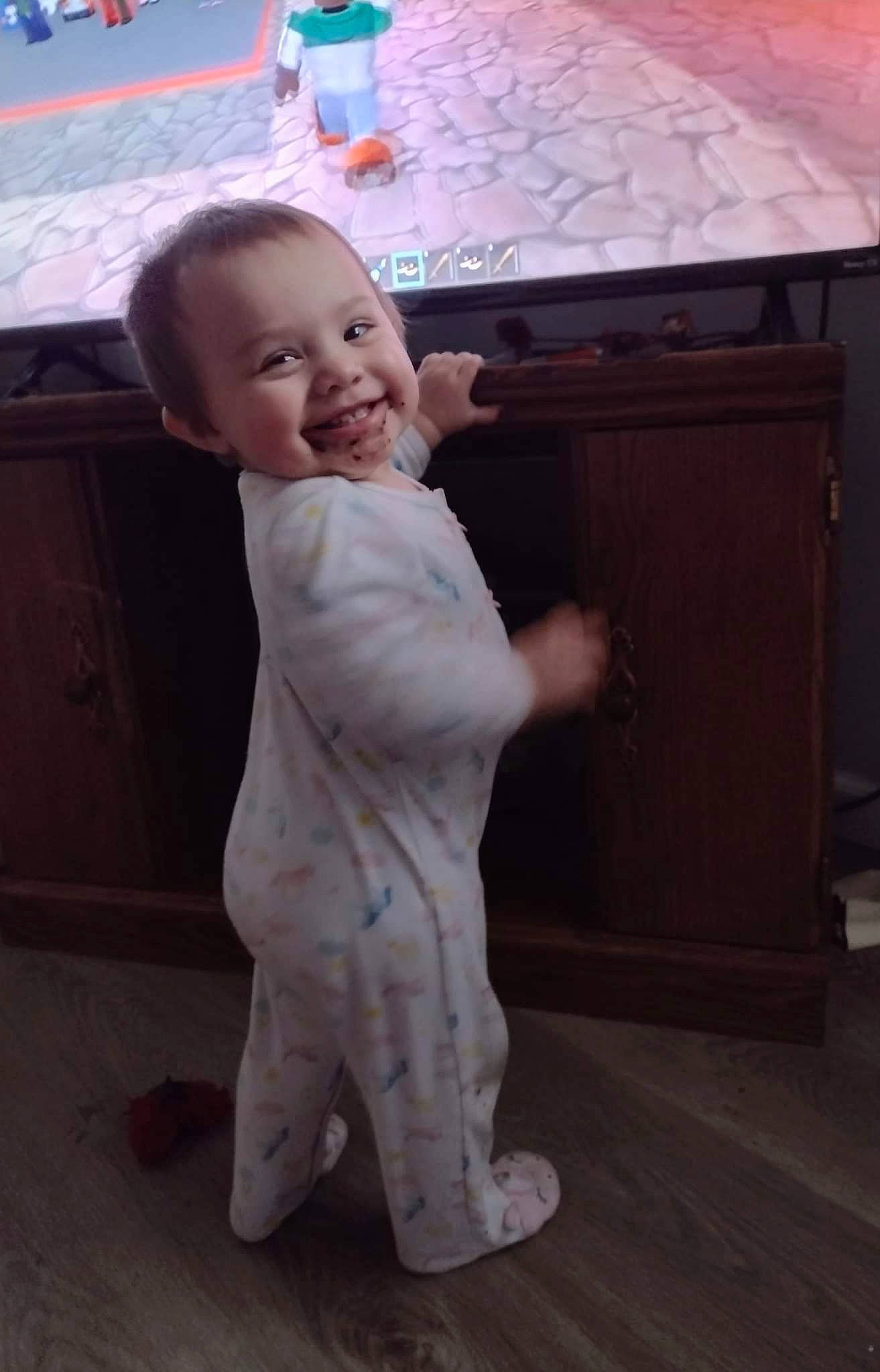 Alessa joined the competition — help win amazing prizes! baby, baby_toddler_clothing, cabinetry, child, floor, flooring, fun, hair, hardwood, head, joy, person, play, room, sitting, sleeve, smile, standing, suit, t_shirt