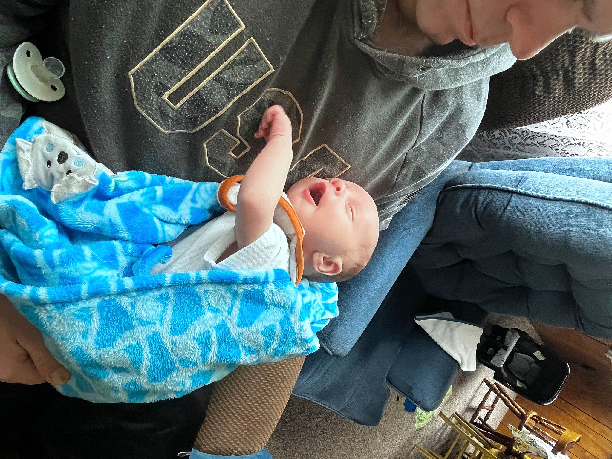 Guy is registered to the contest to win money with this photo: baby, baby_carriage, baby_products, chair, child, comfort, denim, electric_blue, fashion_accessory, fun, hand, lap, leg, pattern, person, plaid, shoe, sitting, sleeve, sneakers