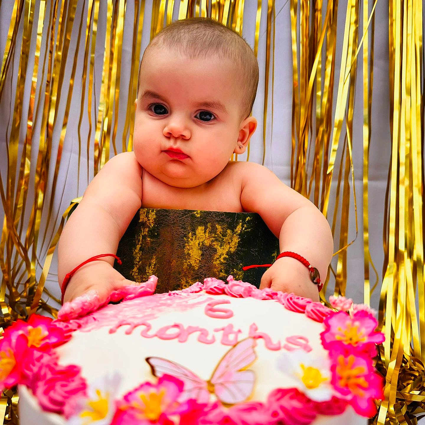 Eva Andreea is registered to the contest to win money with this photo: baby, birthday, butterfly, cake, celebration, child, closeup, cute, decor, event, festive, flower, gold_backdrop, hands, infant, party, pink_frosting, portrait, red_bracelet, smiling