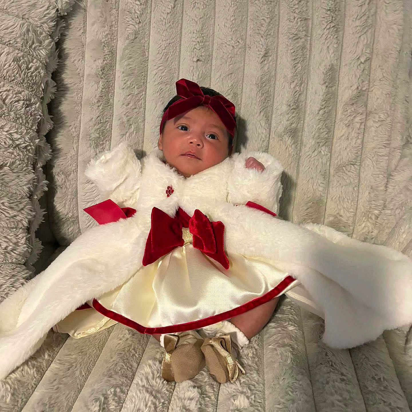 Kennedy joined the competition — help win amazing prizes! baby, infant, red_bow, white_coat, plush_blanket, soft_texture, cute, portrait, indoors, cozy, child, newborn, fashion, clothing, warm, resting, cute_outfit, headband, small_feet, comfortable