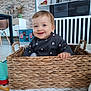 baby, child, basket, smiling, indoor, blue_eyes, woven, furniture, toy, floor, cute, happy, person, clothing, home, decor, hand, sitting, playful, toddler