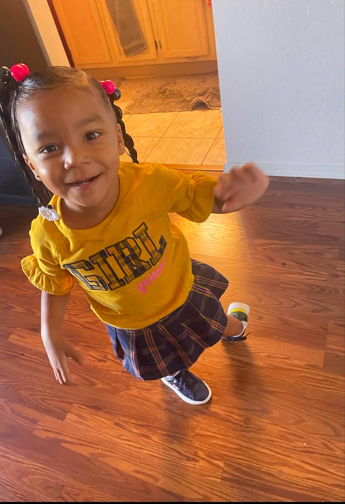 Nevaeh is registered to the contest to win money with this photo: baby_toddler_clothing, door, floor, flooring, fun, happy, hardwood, human_leg, joy, laminate_flooring, person, play, sleeve, smile, sock, t_shirt, thumb, toddler, varnish, wood