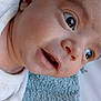 baby, closeup, face, infant, expression, eyes, mouth, skin, clothing, texture, blanket, pattern, white, soft, curious, lying_down, portrait, young_child, head, newborn