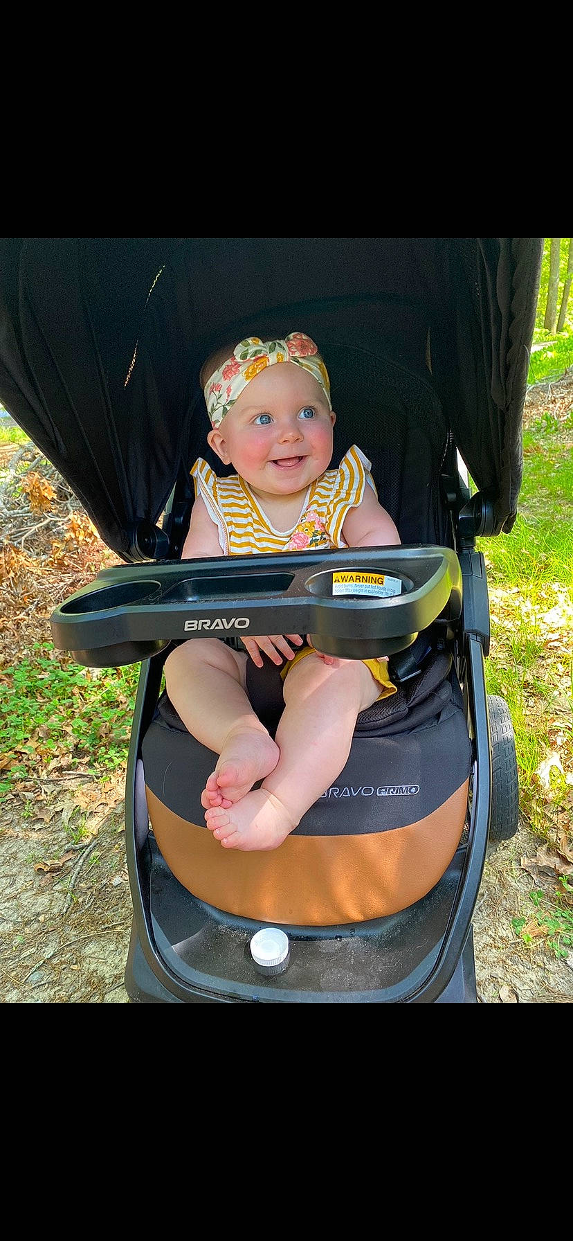Grace is registered to the contest to win money with this photo: auto_part, baby, baby_carriage, baby_products, baby_safety, chair, electric_blue, fashion_accessory, fun, grass, happy, headwear, joy, lap, leisure, people_in_nature, person, personal_protective_equipment, plant, recreation