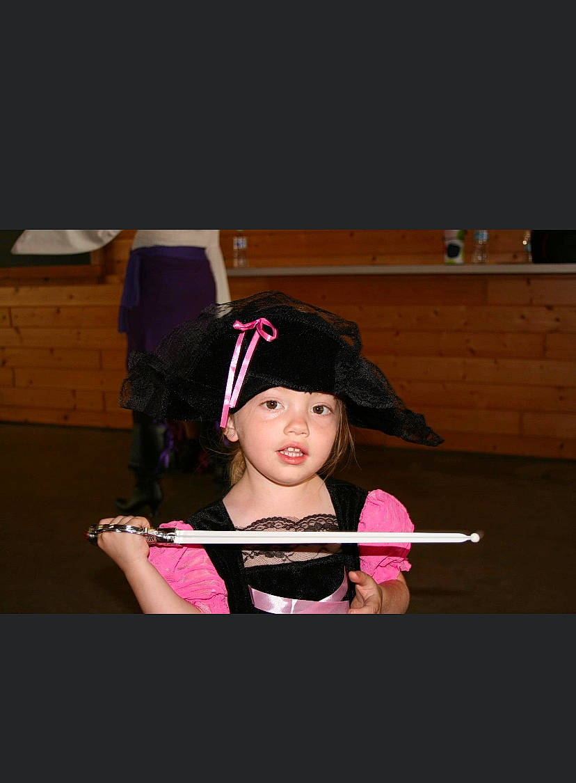 Camryn joined the competition — help win amazing prizes! baseball_cap, black_hair, cap, child, costume, entertainment, event, eyewear, fashion_accessory, flash_photography, fun, headgear, headwear, magenta, person, personal_protective_equipment, recreation, room, shipping_box, sitting