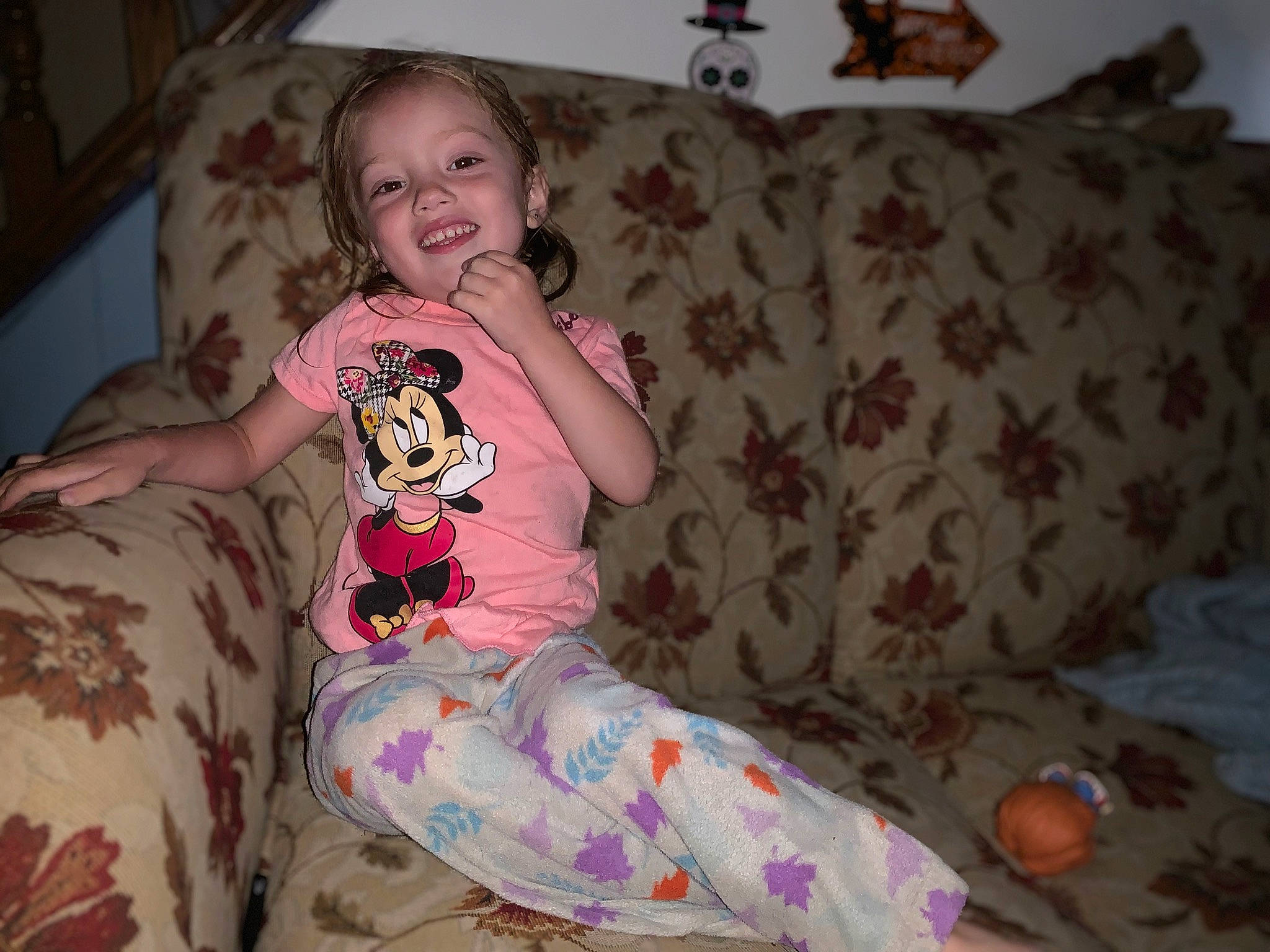 Camryn is registered to the contest to win money with this photo: arm, baby_toddler_clothing, cheek, comfort, couch, eye, face, finger, hair, head, human_body, iris, lap, leg, person, pink, skin, sleeve, smile, textile