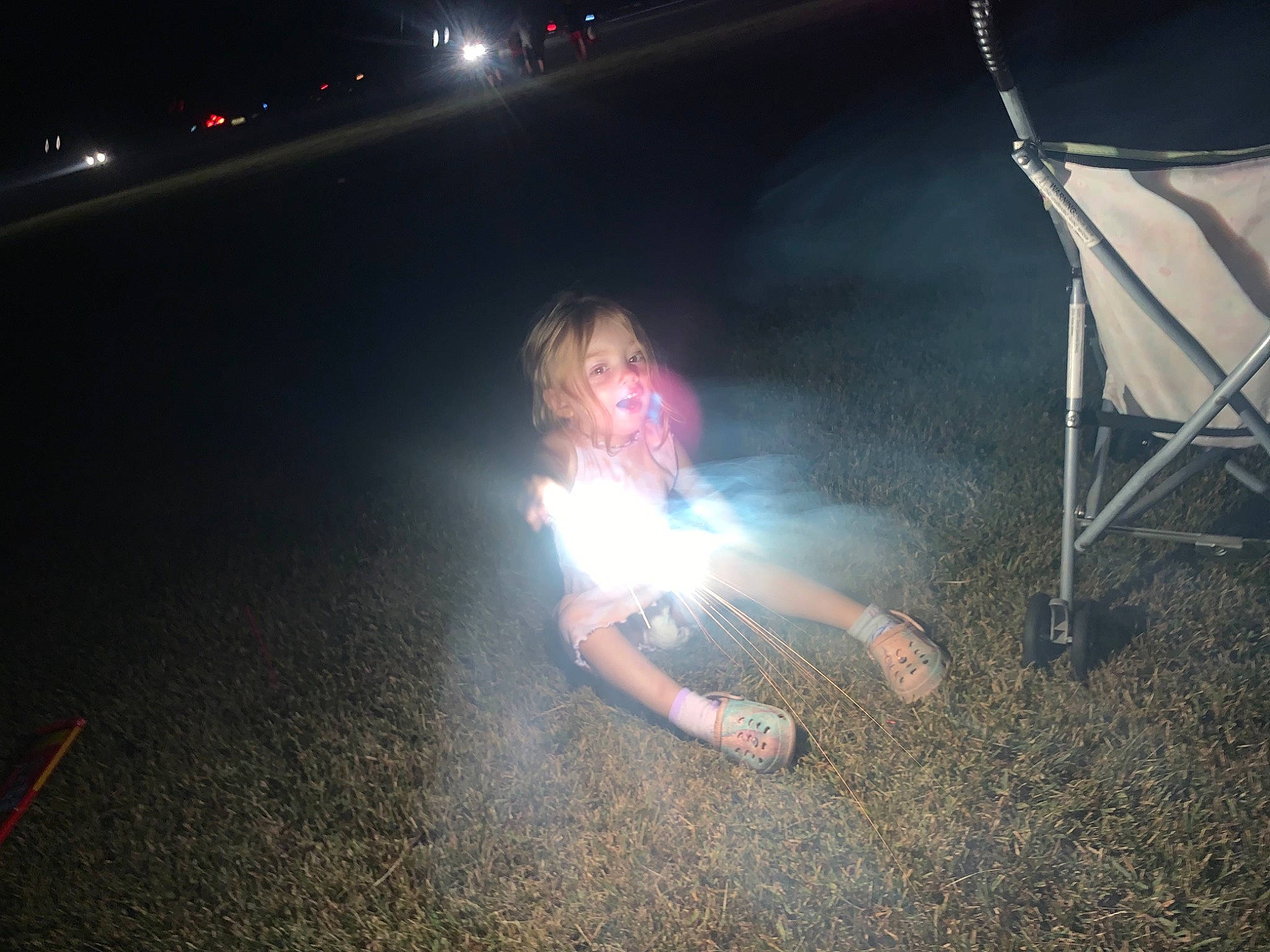Camryn is registered to the contest to win money with this photo: asphalt, automotive_lighting, darkness, entertainment, event, fire, flame, flash_photography, fun, grass, heat, human_leg, leisure, midnight, performance_art, performing_arts, person, road_surface, smoke, space