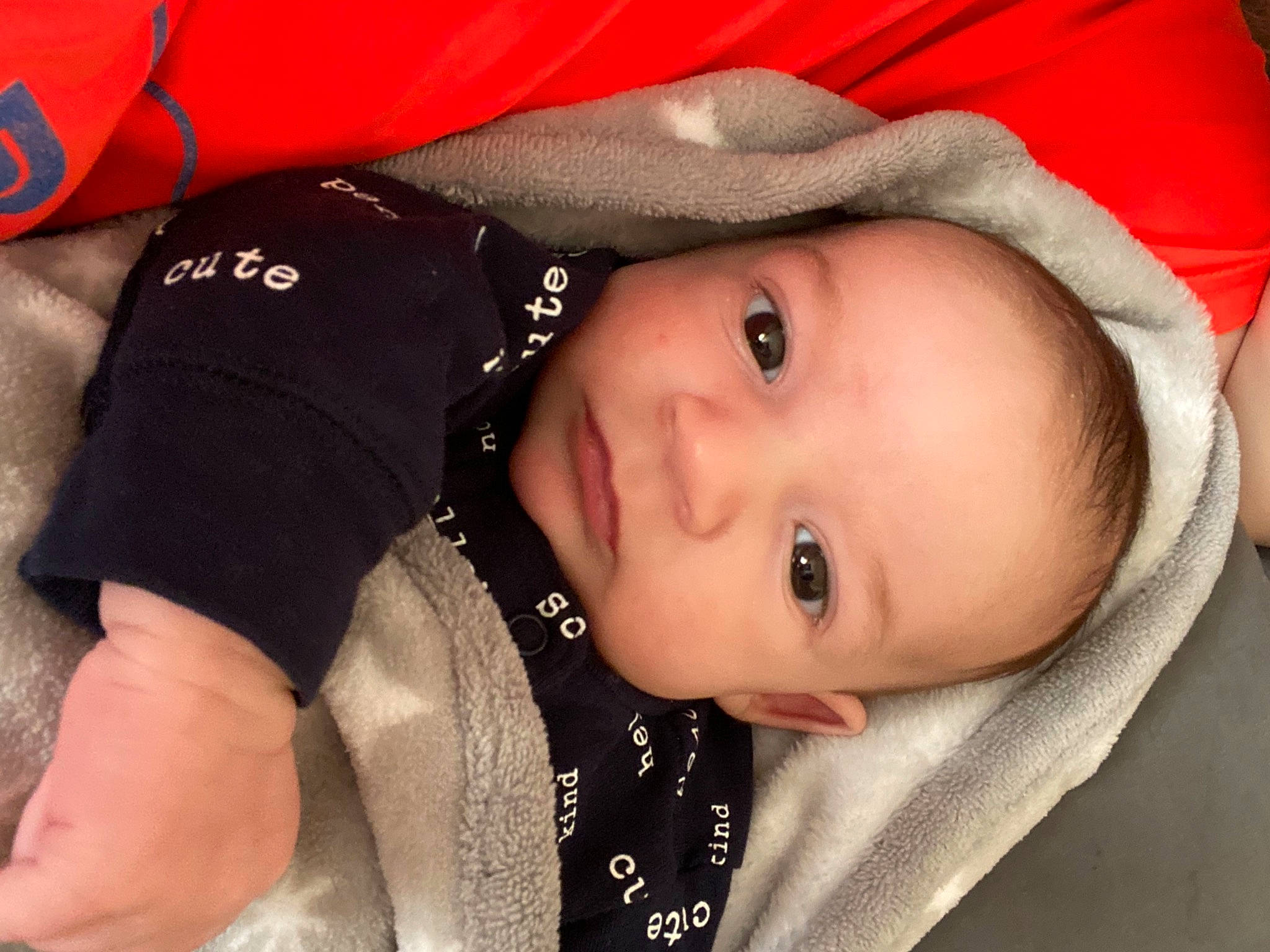 Jayce is registered to the contest to win money with this photo: baby, baby_toddler_clothing, cheek, comfort, cool, eye, eyebrow, eyelash, face, head, human_body, iris, jacket, lip, mouth, nose, person, red, skin, sleeve