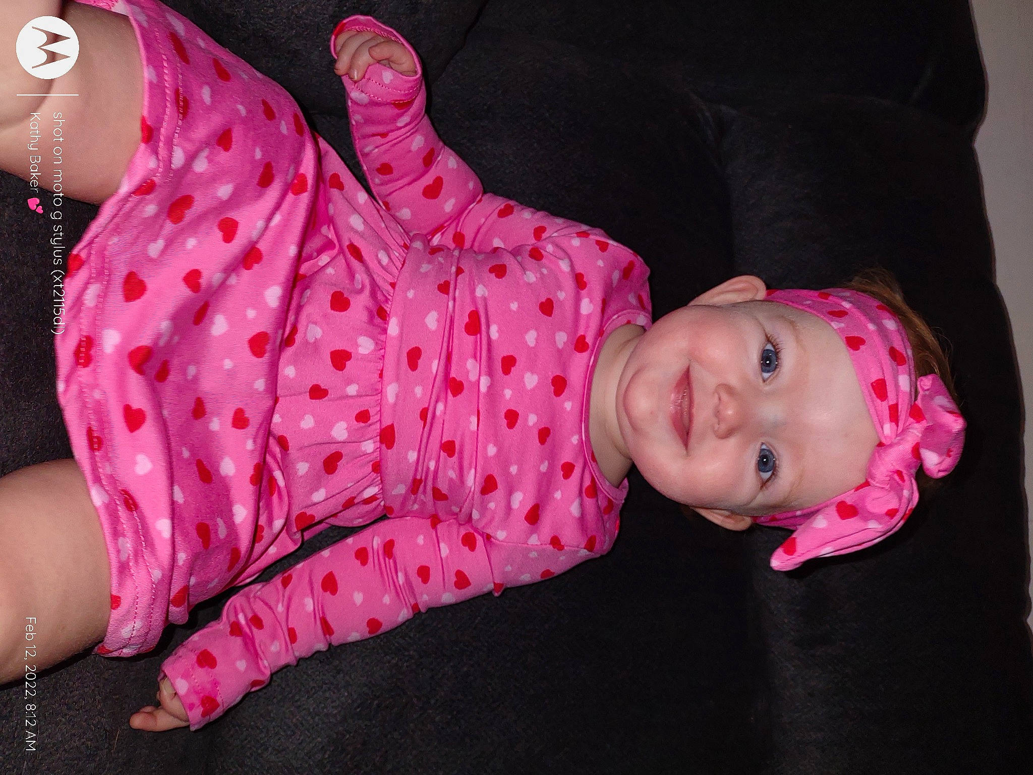 Riley is registered to the contest to win money with this photo: baby, baby_products, baby_toddler_clothing, child, fun, gesture, headwear, human_body, human_leg, joint, joy, lip, magenta, pattern, person, pink, sitting, skin, sleeve, smile