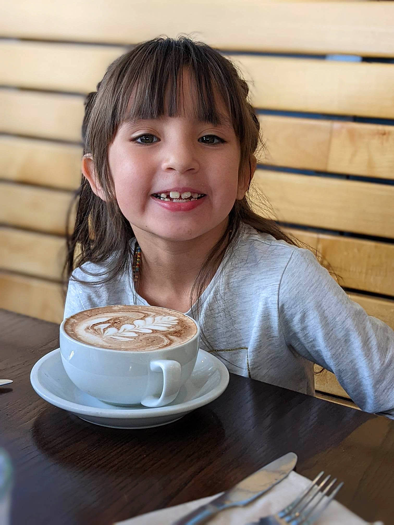 Xitlally is registered to the contest to win money with this photo: caffe_macchiato, coffee, coffee_cup, cuisine, cup, dish, drinkware, espressino, face, flat_white, food, ingredient, joy, kitchen_utensil, person, plate, serveware, smile, spoon, table