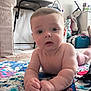 Joey is registered to the contest to win money with this photo: baby, infant, child, play_mat, indoor, carpet, curious, face, hands, furniture, lamp, bag, blanket, floor, toy, room, portrait, skin, head, expression