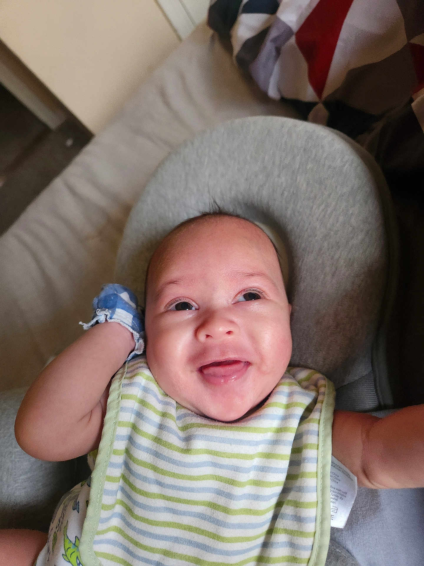 Jamir joined the competition — help win amazing prizes! baby, infant, smiling, bib, mittens, face, person, indoor, happy, child, cute, expression, clothing, seat, head, skin, closeup, portrait, newborn, comfort