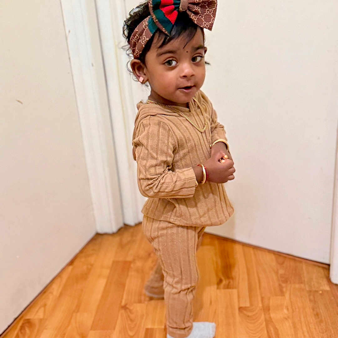 Aadiyah joined the competition — help win amazing prizes! accessories, child, clothing, face, female, girl, hair, happy, hardwood, head, jewelry, necklace, pants, person, photography, portrait, sleeve, smile, standing, wood
