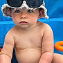 Sohan participe au concours pour gagner de l'argent avec cette photo : baby, child, bucket_hat, sunglasses, diaper, blue_background, toy, skin, chubby, sitting, curious, serious_expression, frayed_hat, summer, outdoor, water, playtime, cute, infant, portrait