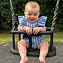 baby, child, swing, outdoor, playground, smiling, happy, blue_clothing, striped_clothing, barefoot, grass, trees, metal_chains, seat, infant, cute, summer, fun, person, portrait