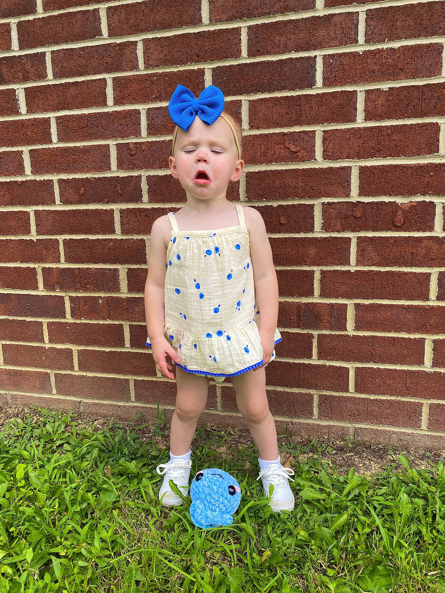 Harper Rae is registered to the contest to win money with this photo: baby_toddler_clothing, ball, brick, brickwork, child, electric_blue, football, fun, grass, happy, headgear, human_leg, knee, pattern, person, polka_dot, sports_equipment, t_shirt, toddler
