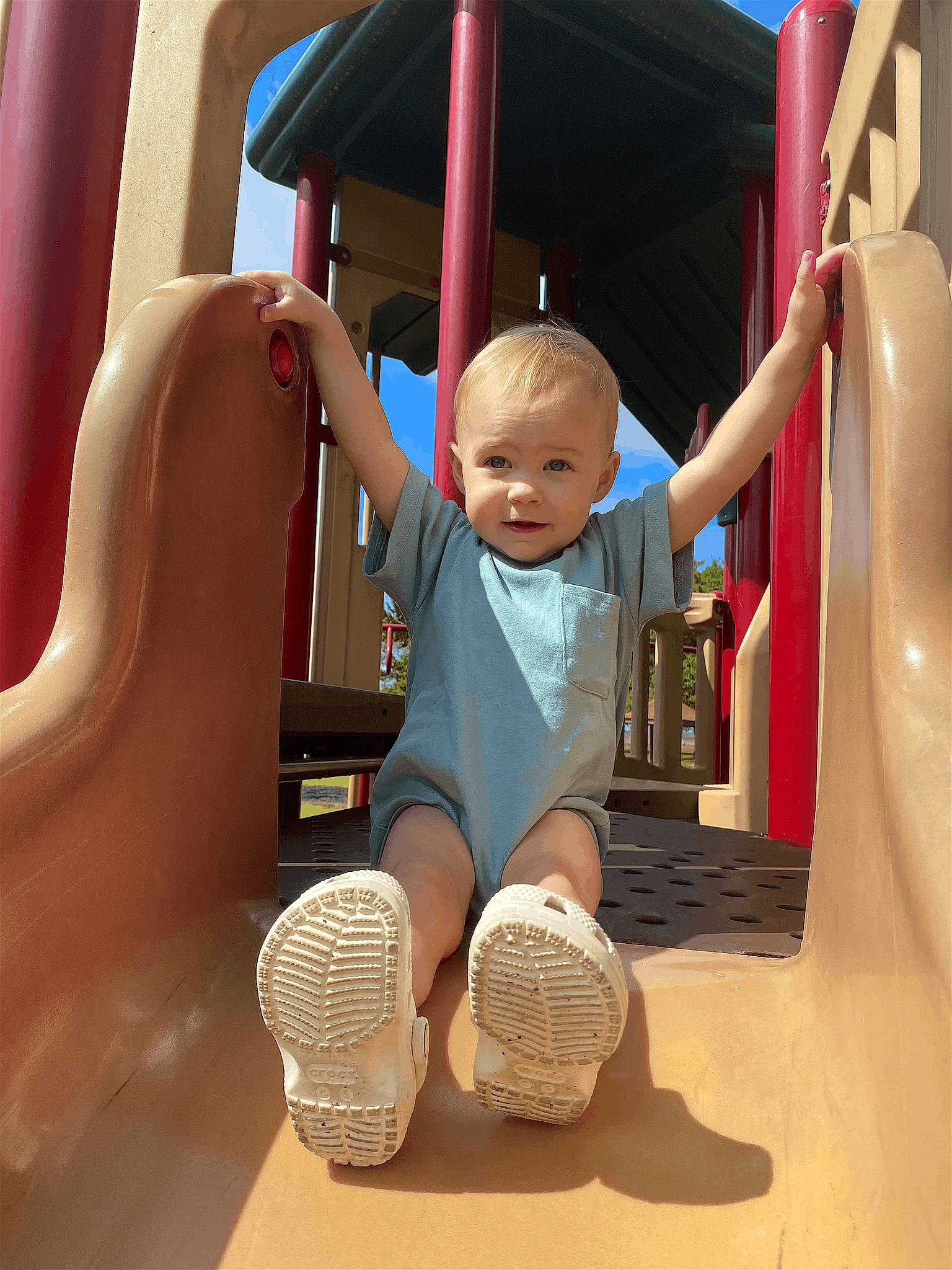 Harper Rae is registered to the contest to win money with this photo: baby, baby_toddler_clothing, child, chute, city, comfort, facial_expression, flooring, fun, leisure, outdoor_play_equipment, person, play, playground, playground_slide, product, recreation, sitting, smile, toddler