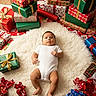 Noé participe au concours pour gagner de l'argent avec cette photo : baby, bow, child, christmas, cozy, cute, festive, fluffy_rug, gift, holiday, infant, lying_down, pile_of_gifts, portrait, present, ribbon, shag_rug, surrounded_by_gifts, white_onesie, wrapping_paper