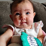Maisie Jo joined the competition — help win amazing prizes! baby, child, blue_eyes, teething_toy, blanket, couch, curly_hair, infant, close_up, cute, person, indoors, soft_lighting, white_clothing, plush, portrait, sitting, chubby_cheeks, face, expression