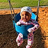 Allison joined the competition — help win amazing prizes! baby, child, infant, swing, playground, outdoor, smiling, happy, portrait, blue_swing, hello_kitty, pink_clothing, headwear, gloves, playground_mulch, grass, suburban, houses, sunlight, playtime