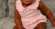 Allison is registered to the contest to win money with this photo: baby, child, infant, sitting, portrait, smiling, looking_at_camera, pink_outfit, striped_clothing, dress, shoes, gray_blanket, furry_blanket, couch, indoors, home, door, wall, earrings, cute