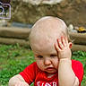 Roger joined the competition — help win amazing prizes! baby, child, infant, red_shirt, grass, outdoor, portrait, head, hand, expression, puzzled, sitting, cute, young, nature, background_blur, photography_watermark, skin, face, person