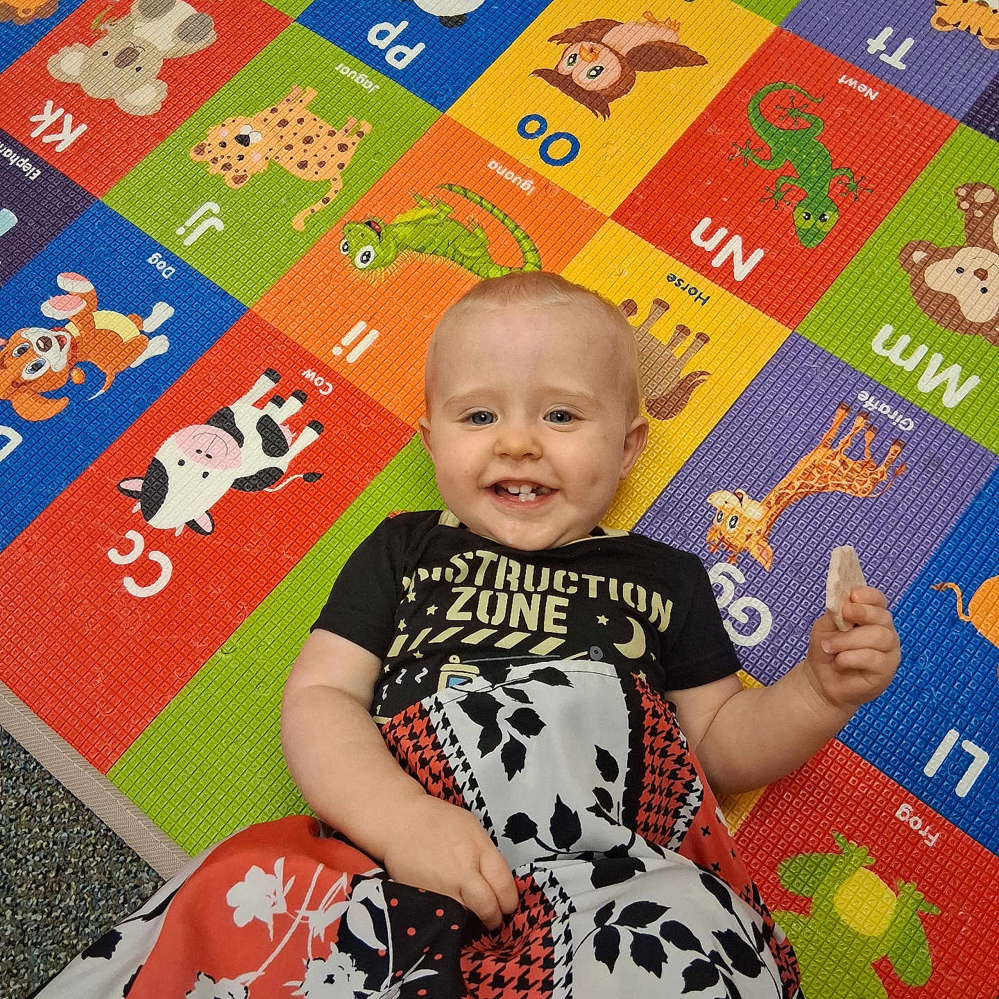 Roger joined the competition — help win amazing prizes! baby, child, smiling, blanket, colorful, animal_mat, alphabet, toy_mat, floor, indoor, cute, happy, person, face, clothing, food, snack, pattern, playful, young