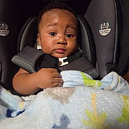 Zy'Aire is registered to the contest to win money with this photo: baby, car_seat, blanket, child, infant, face, portrait, indoor, cozy, cute, expression, clothing, sitting, hands, comfort, soft, warm, young, person, head
