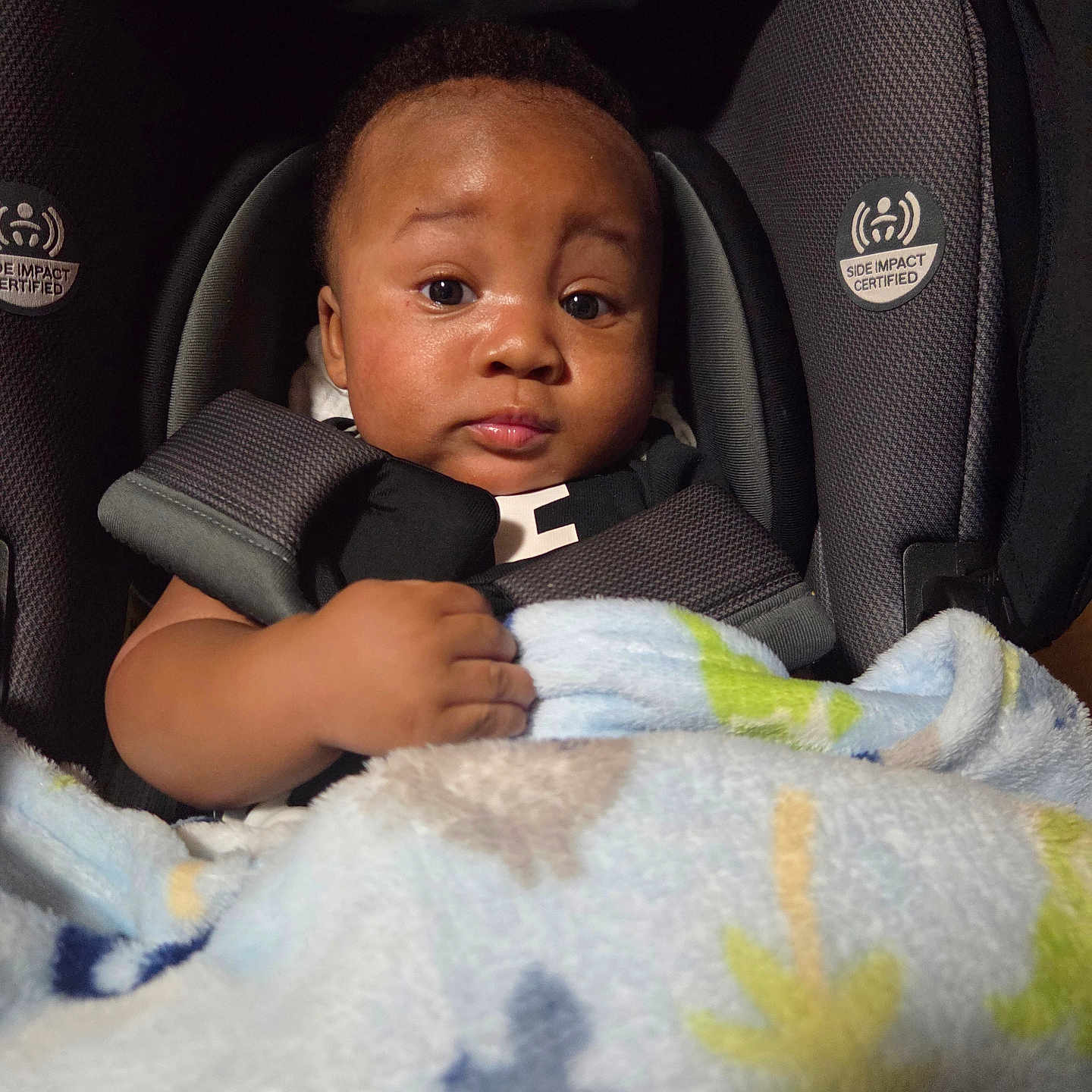 Zy'Aire is registered to the contest to win money with this photo: baby, car_seat, blanket, child, infant, face, portrait, indoor, cozy, cute, expression, clothing, sitting, hands, comfort, soft, warm, young, person, head