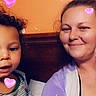 child, woman, smiling, selfie, hearts, curly_hair, bedroom, orange_wall, purple_clothing, striped_shirt, digital_hearts, family, indoor, happy, casual, people, head_and_shoulders, affection, love, portrait