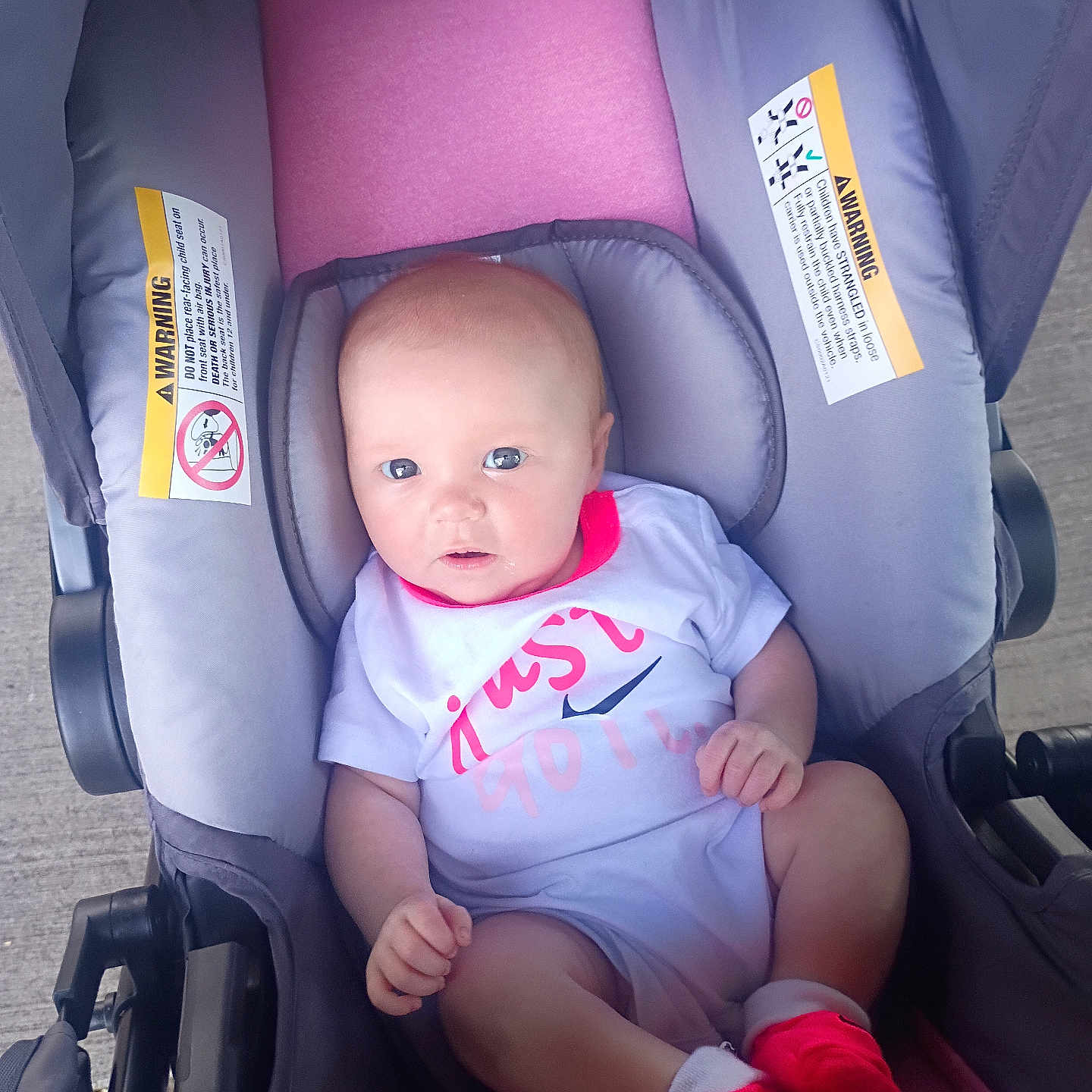 Faith is registered to the contest to win money with this photo: baby, child, stroller, infant, clothing, onesie, pink, gray, socks, seat, cute, person, portrait, young, face, outdoor, expression, small, babywear, newborn