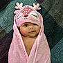 Nomi is registered to the contest to win money with this photo: baby, bathtowel, blanket, bonnet, cap, clothing, face, happy, hat, head, hood, newborn, person, photography, portrait, quilt, smile, spa, towel