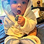 Nomi joined the competition — help win amazing prizes! baby, biting, blanket, bonnet, clothing, doll, eating, face, food, hat, head, hood, person, photography, portrait, surprised, toy, yawning