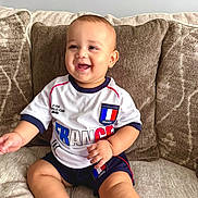 Rafael joined the competition — help win amazing prizes! baby, child, smiling, sitting, couch, pillow, indoor, clothing, shorts, tshirt, football, world_cup, france, happy, cute, portrait, skin, hand, foot, home