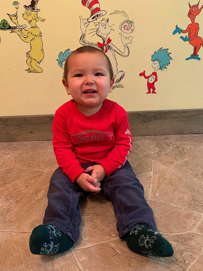 Mateo De Jesus is registered to the contest to win money with this photo: art, baby, baby_toddler_clothing, child, event, flooring, fun, happy, head, holiday, organ, pattern, people_in_nature, person, red, shoe, sitting, sleeve, smile, toddler