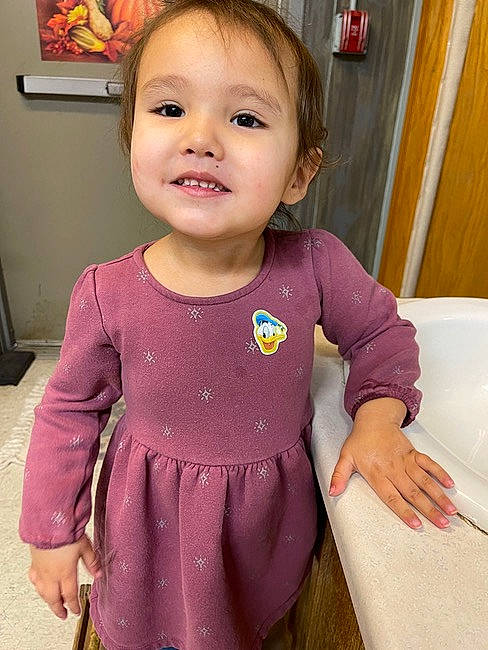 Selena is registered to the contest to win money with this photo: baby_toddler_clothing, cheek, child, eyelash, facial_expression, hairstyle, happy, head, iris, joint, joy, lip, neck, person, picture_frame, pink, shoulder, skin, sleeve, smile