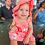 toddler, child, baby, hat, dress, smile, blue_eyes, table, glass_table, person, indoor, blurred_background, adult, sitting, happy, casual, cute, pink_clothing, sunhat, portrait