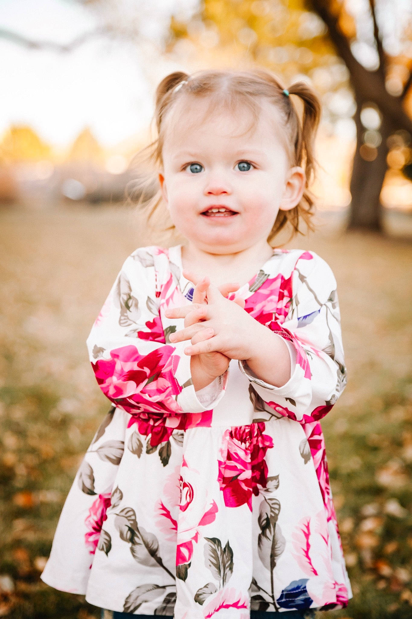 Claira is registered to the contest to win money with this photo: baby, baby_toddler_clothing, child, day_dress, dress, flash_photography, fun, gesture, grass, happy, joy, pattern, people_in_nature, person, pink, plant, skin, sleeve, smile, standing