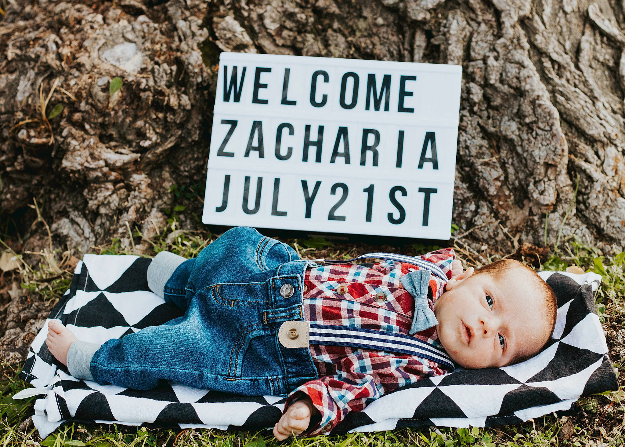 Zacharia joined the competition — help win amazing prizes! baby, child, font, grass, nap, person, photo_caption, photography, plant, recreation, sign, signage, toddler, tree