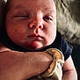 James is registered to the contest to win money with this photo: baby, bodypart, crying, face, finger, frown, hand, head, newborn, person, photography, portrait, sad, skin, sleeping, towel