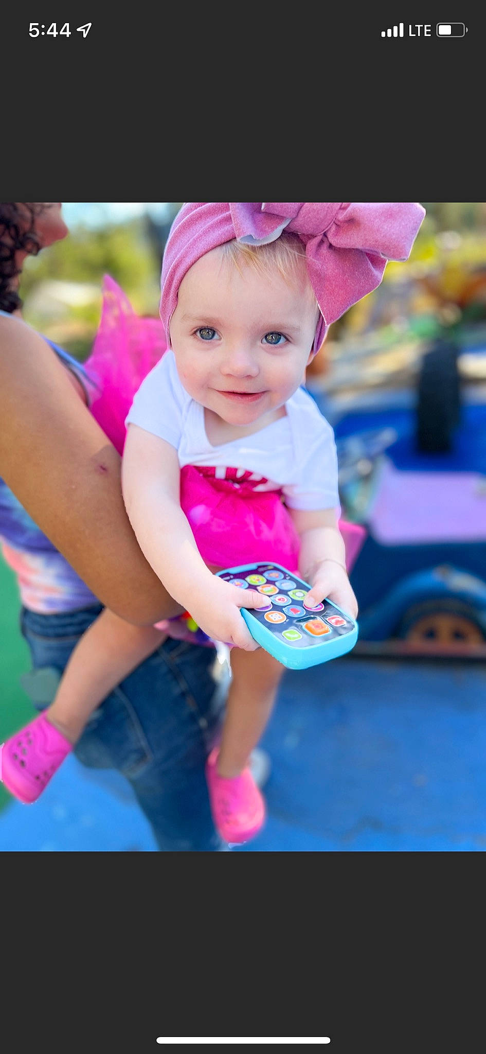 Beyla is registered to the contest to win money with this photo: baby_toddler_clothing, child, electric_blue, event, fun, gesture, grass, happy, joy, leisure, magenta, person, pink, play, purple, recreation, shorts, sitting, skin, smile