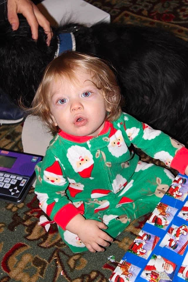 Damian is registered to the contest to win money with this photo: baby, baby_toddler_clothing, child, christmas, christmas_eve, comfort, event, flooring, fun, happy, holiday, lap, linens, pattern, person, play, room, sitting, sleeve, surprise