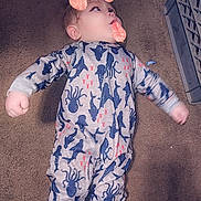 Wayne is registered to the contest to win money with this photo: animal_print, baby, carpet, child, childwear, cute, dog_filter, ears, face_filter, floor, indoor, infant, lying_down, nose, octopus, onesie, pajamas, playful, shark, tongue