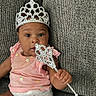 baby, infant, tiara, scepter, couch, diaper, bandage, pink_clothing, cute, child, portrait, indoor, person, jewelry, headwear, sitting, expression, young_child, adorable, texture