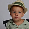 Kobi joined the competition — help win amazing prizes! child, toddler, portrait, face, hat, straw_hat, green_clothing, knitwear, sitting, chair, indoor, studio, gray_background, looking_at_camera, serious, young_boy, fashion, close_up, photography, safe