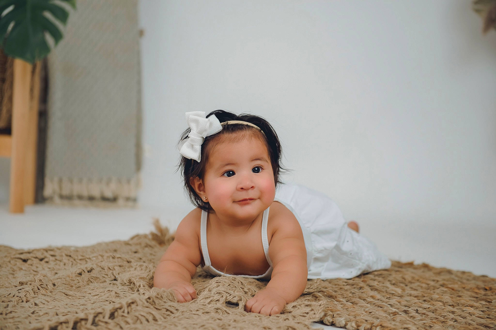 Jamie is registered to the contest to win money with this photo: baby, baby_toddler_clothing, comfort, eye, fashion_accessory, flash_photography, flooring, fun, fur, hair_accessory, happy, headband, headgear, headpiece, jewellery, joy, linens, person, sitting, smile