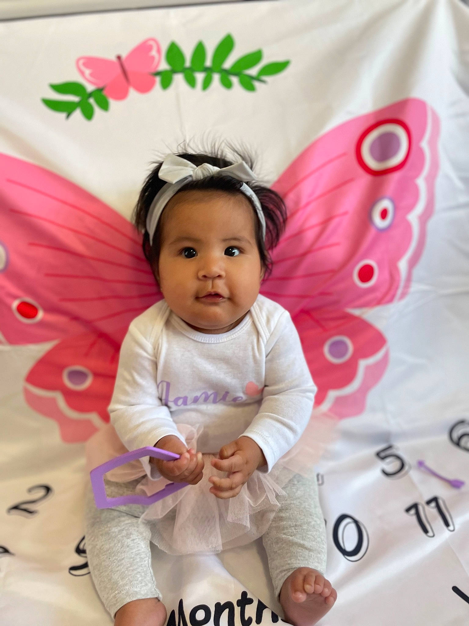 Jamie joined the competition — help win amazing prizes! baby, baby_products, baby_toddler_clothing, child, costume_hat, fashion_accessory, font, hair_accessory, happy, insect, jewellery, magenta, pattern, person, pink, pollinator, product, sleeve, smile, toddler