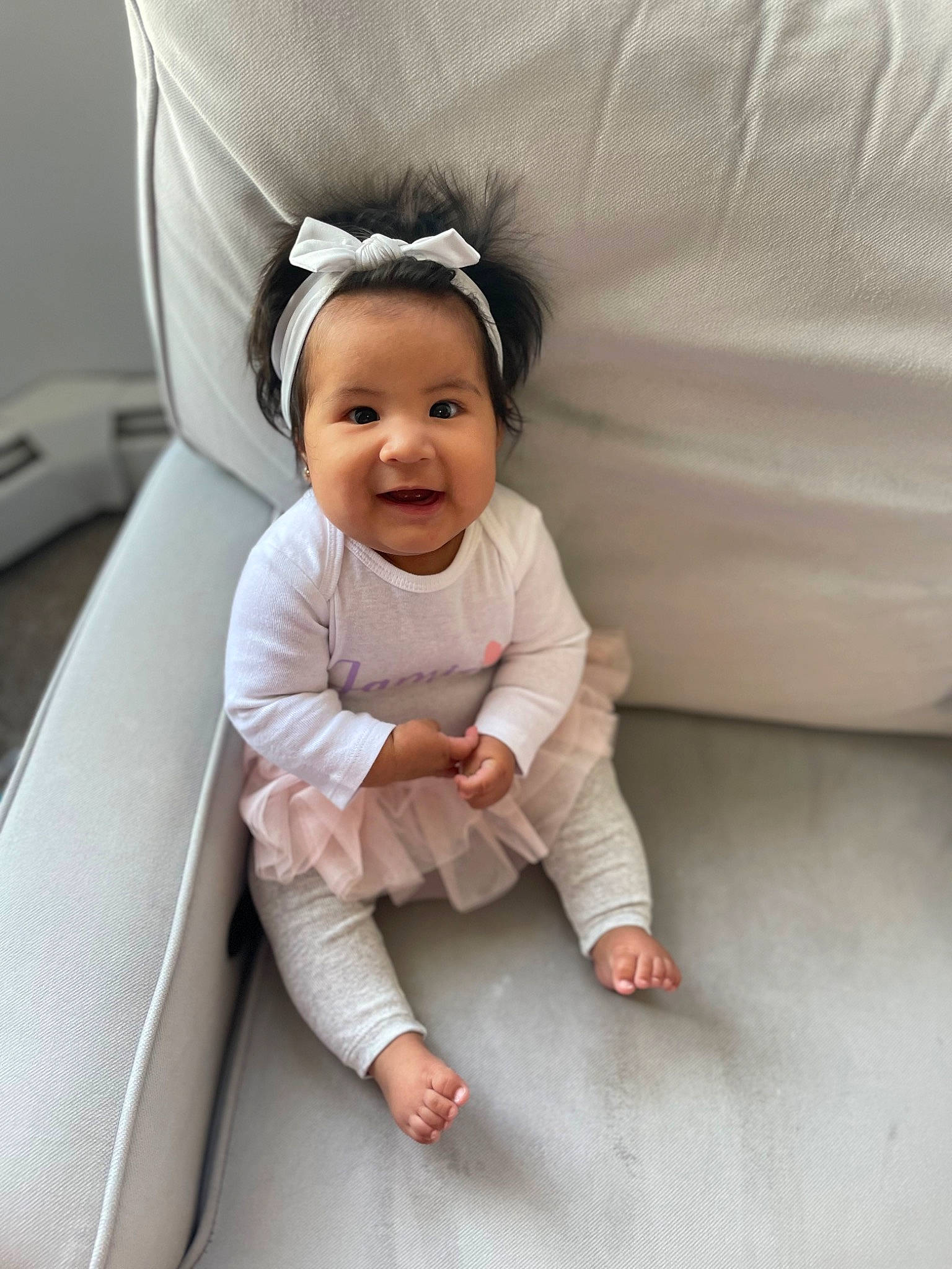 Jamie joined the competition — help win amazing prizes! baby, baby_toddler_clothing, child, comfort, couch, eye, fashion_accessory, foot, happy, human_body, joy, linens, person, product, room, sitting, skin, sleeve, smile, thumb